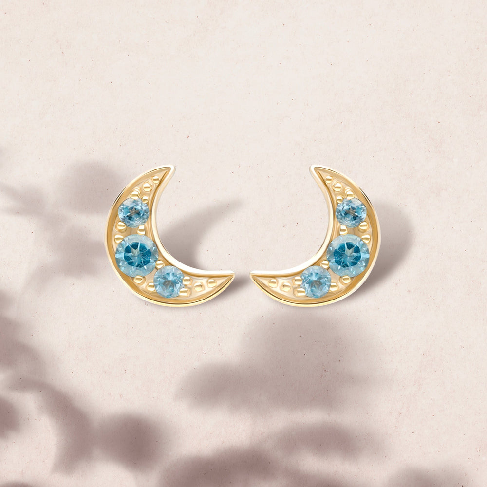 135E1819019 Night Sky London Blue Topaz Moon Stud Earrings in 9ct Yellow Gold On Model